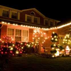 Front of House at Night With Red and White Christmas Lights