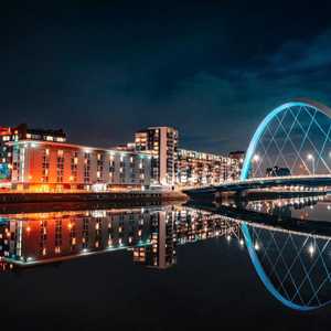 Glasgow City at Night With River and a Bridge in Bright Lights