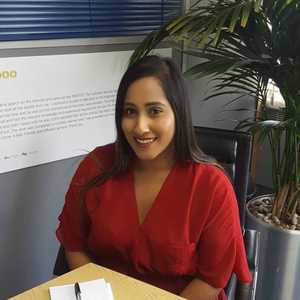 Salma at Desk Next to Plant