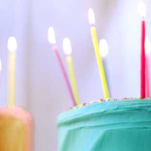 Green and Pink Birthday Cakes with Lit Candles