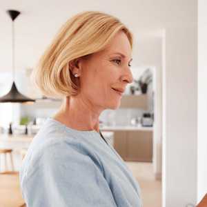 Woman Checking The Thermostat