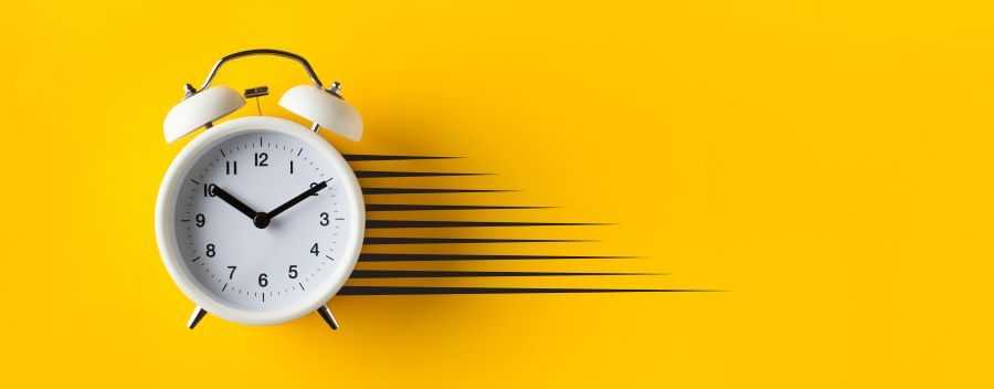 White Alarm Clock With Over a Yellow Background and Black Go Faster Stripes