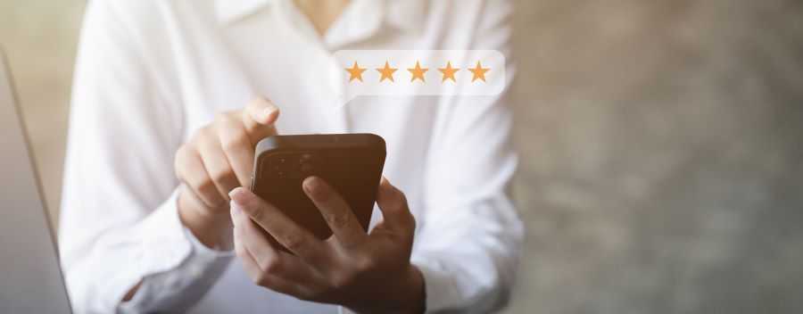 Person Using Their Phone to Leave a 5 Star Review