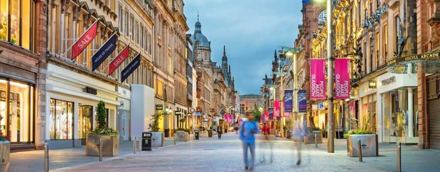 Glasgow Shopping District in the Evening With Blurred People in the Foreground