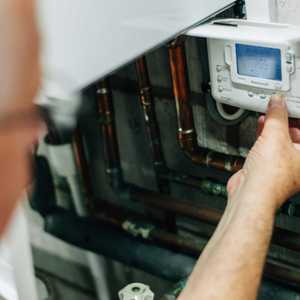 Engineer Checking Boiler Controls