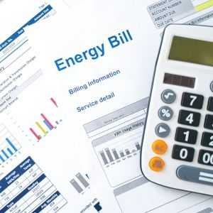 a pile of energy bills and calculator 