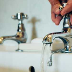 Tap with Water Running into The Sink